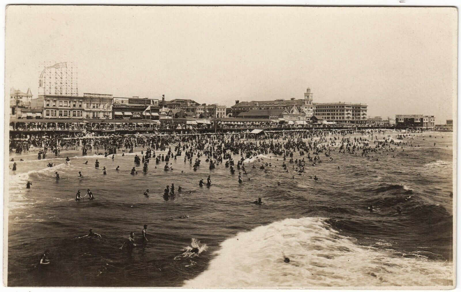 Atlantic City - Hotels Boardwalk Beach Bathers and the Atlantic Ocean are all covered in this wide agle shot - Almost looks like fun - c 1910