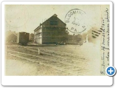 Quakertown - Railroad view with siding, frieght car and industrial looking building - 1905 - Post from PA but vendor identified tthe card as Quakertown