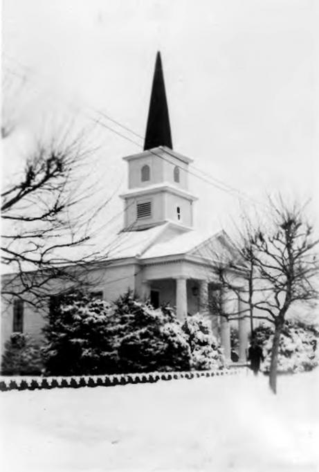 Egg Harbor City - he Moravian Church on Boston Avenue shows the church after a heavy snowstorm- In front of the church is a person identified as Rev. Bender who was the pastor during the 1930s - c 1935 - EHC