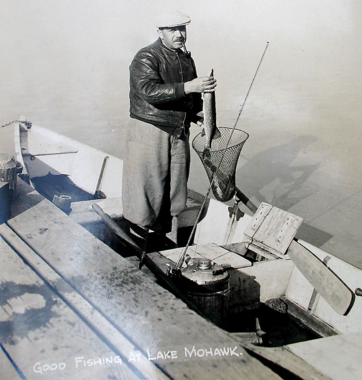 Sparta - Lake Mohawk - A good catch - A man afish in a boat at the dock - c 1930